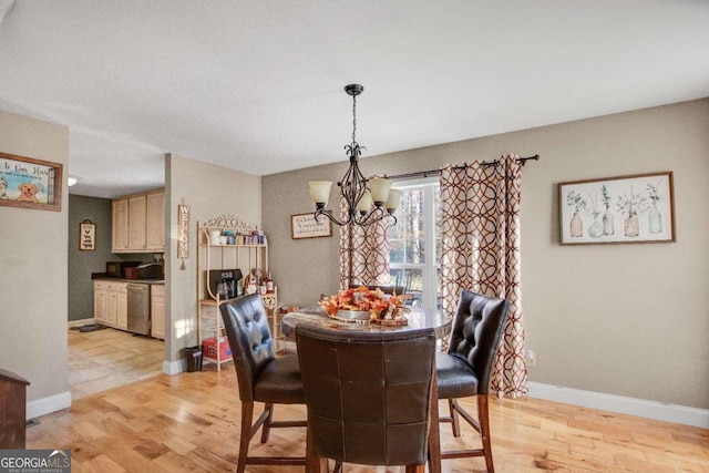 dining room featuring an inviting chandelier and light hardwood / wood-style flooring