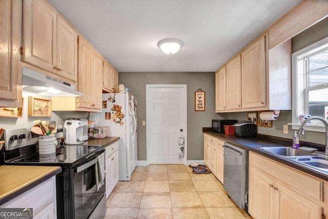 kitchen with appliances with stainless steel finishes, light brown cabinets, light tile patterned floors, and sink