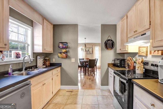 kitchen featuring stainless steel appliances, sink, light brown cabinets, light tile patterned floors, and an inviting chandelier