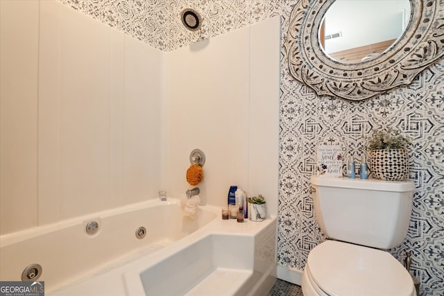 bathroom featuring washtub / shower combination and toilet