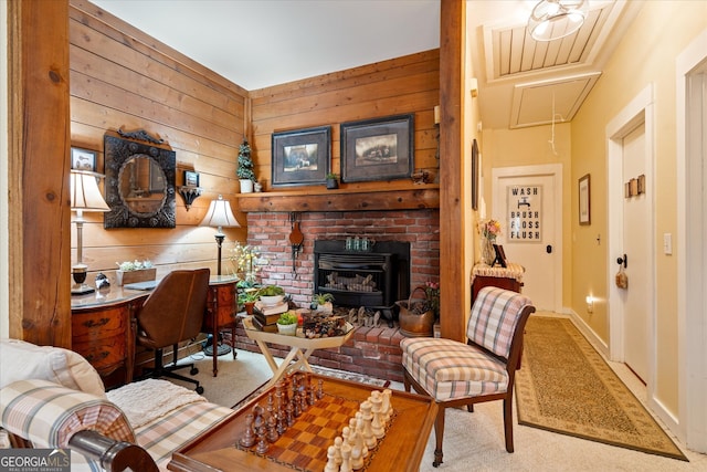 carpeted living room featuring a fireplace and wooden walls