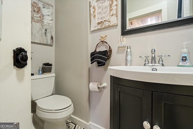 bathroom featuring tile patterned floors, vanity, and toilet