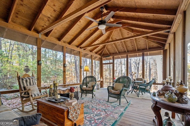 sunroom with vaulted ceiling with beams, ceiling fan, and wooden ceiling