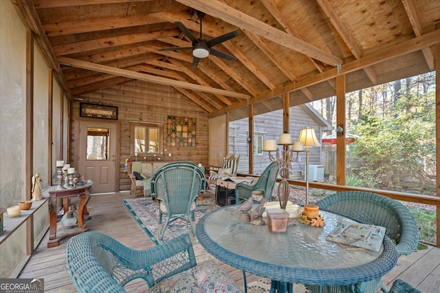 sunroom with lofted ceiling with beams, ceiling fan, and wooden ceiling