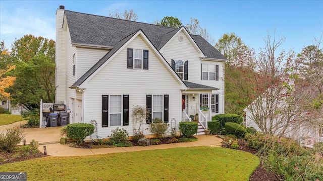 view of property featuring a front lawn