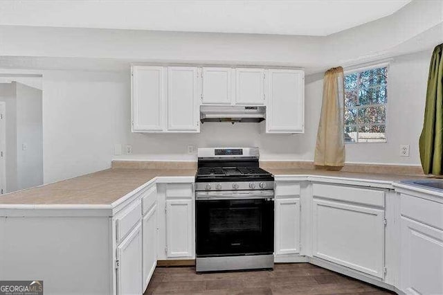 kitchen with kitchen peninsula, white cabinetry, and stainless steel gas range