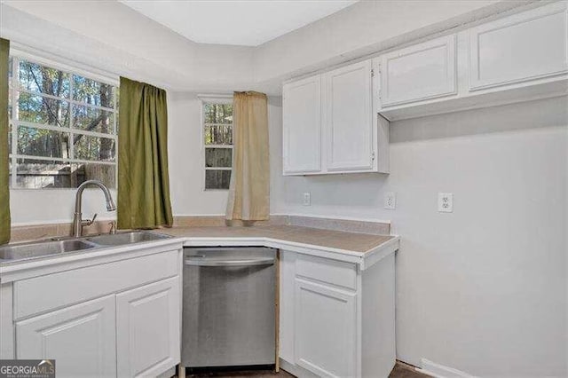 kitchen featuring dishwasher, white cabinetry, sink, and a wealth of natural light