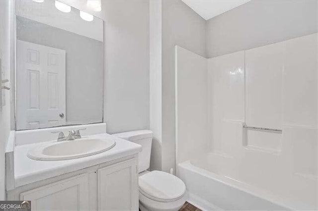 full bathroom featuring vanity, bathtub / shower combination, and toilet