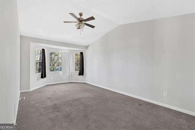 carpeted spare room with ceiling fan and lofted ceiling