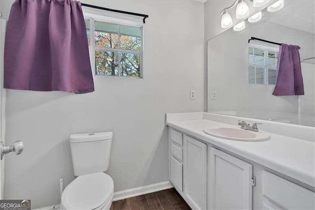 bathroom featuring hardwood / wood-style flooring, vanity, and toilet