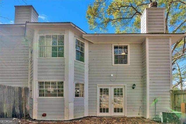 back of property featuring central AC unit and french doors