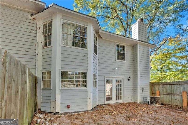 rear view of house featuring central AC unit