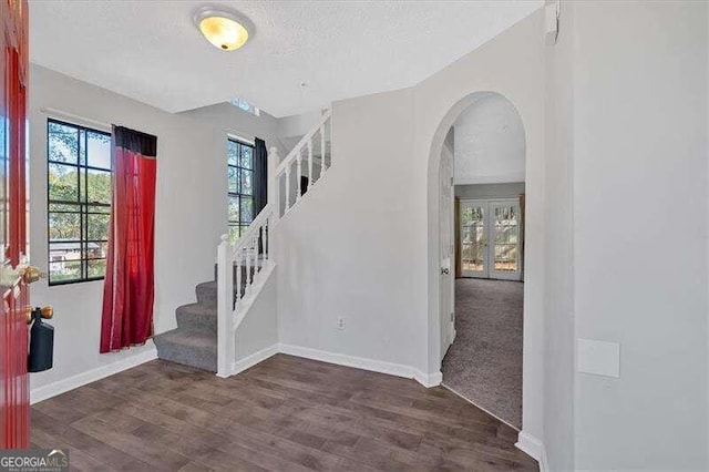 entrance foyer featuring dark hardwood / wood-style flooring and a textured ceiling