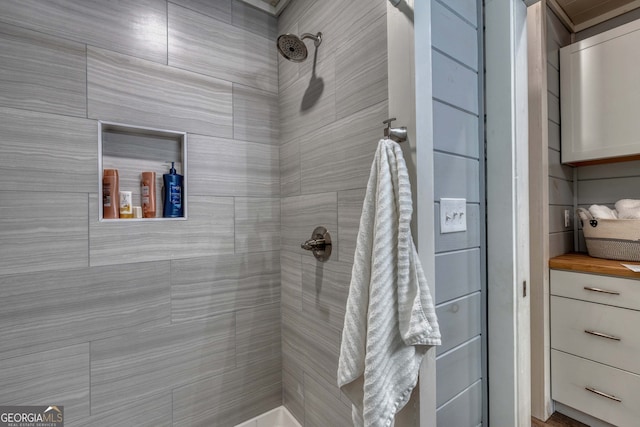 bathroom with a tile shower