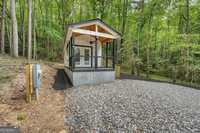 view of side of property featuring french doors and ceiling fan