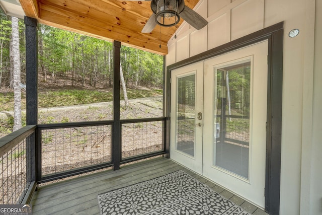 unfurnished sunroom featuring lofted ceiling, a wealth of natural light, and ceiling fan