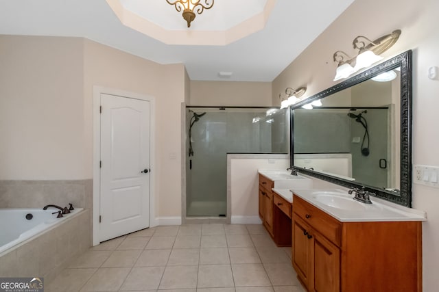 bathroom featuring vanity, a tray ceiling, tile patterned floors, and independent shower and bath