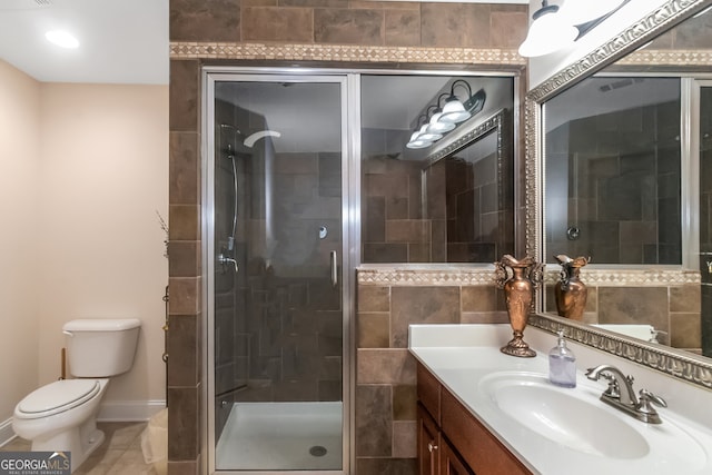 bathroom featuring vanity, toilet, and a shower with door