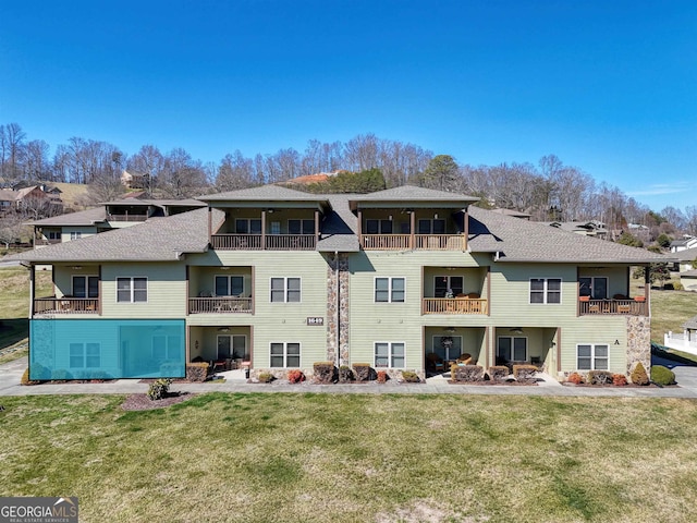 rear view of property with a lawn