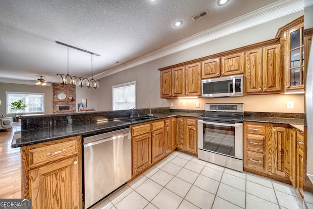 kitchen with a healthy amount of sunlight, sink, stainless steel appliances, and a textured ceiling