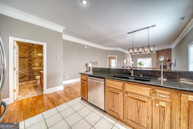 kitchen featuring sink, dishwasher, light hardwood / wood-style flooring, a textured ceiling, and ornamental molding