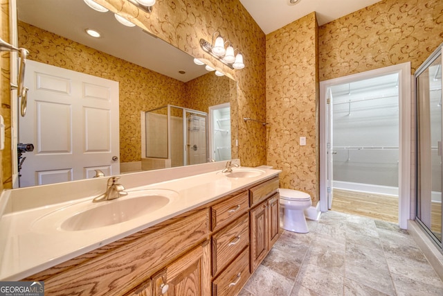 bathroom with vanity, toilet, and an enclosed shower