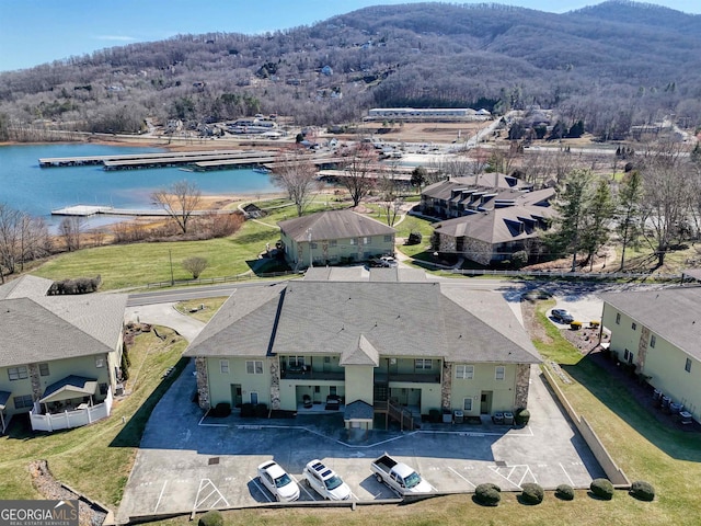 birds eye view of property with a water and mountain view