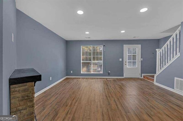 unfurnished living room with dark hardwood / wood-style floors