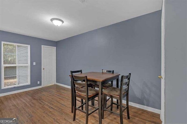 dining area featuring dark wood-type flooring