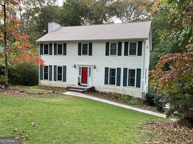 colonial home featuring a front yard