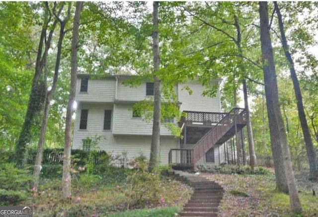 rear view of house with a wooden deck