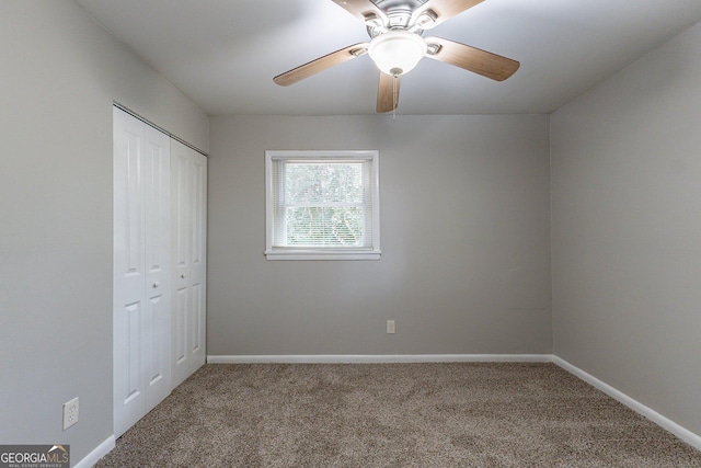 unfurnished bedroom with carpet, a closet, and ceiling fan