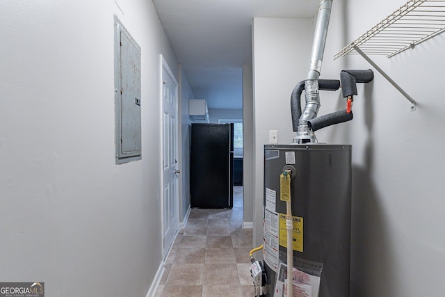 utility room featuring electric panel and water heater