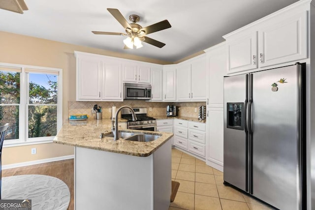 kitchen with kitchen peninsula, white cabinetry, and appliances with stainless steel finishes