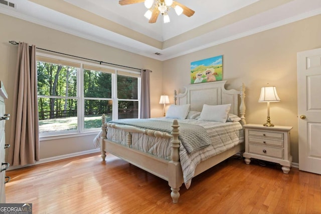 bedroom featuring ceiling fan, crown molding, and light wood-type flooring