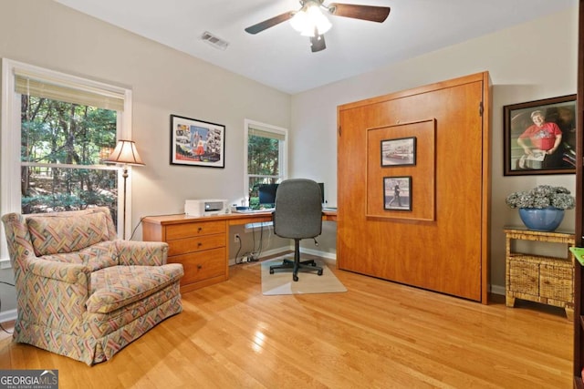 office space with ceiling fan and light hardwood / wood-style floors