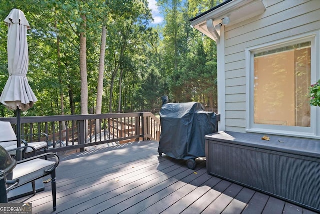 wooden deck featuring a grill