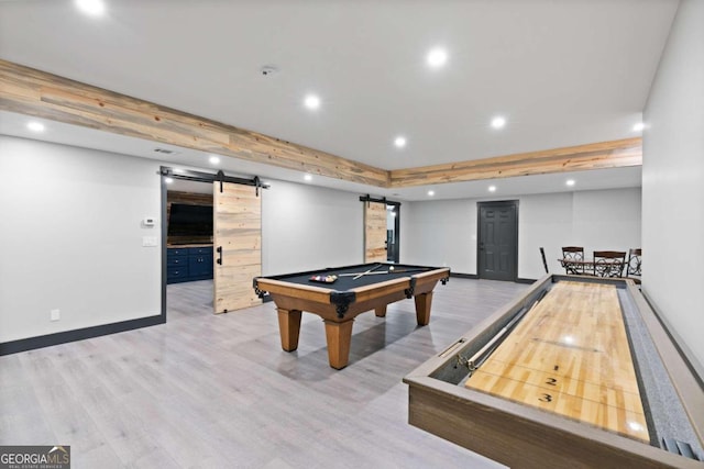 recreation room with a barn door, billiards, and light hardwood / wood-style flooring