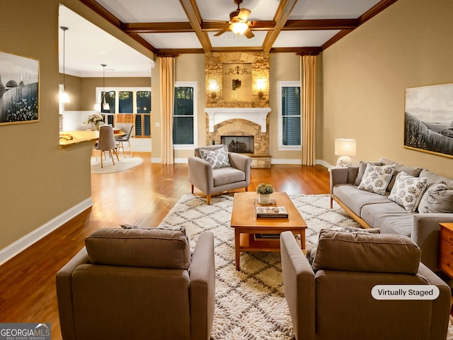 living room with coffered ceiling, ceiling fan, a fireplace, beamed ceiling, and wood-type flooring