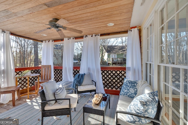 sunroom / solarium featuring wooden ceiling and ceiling fan