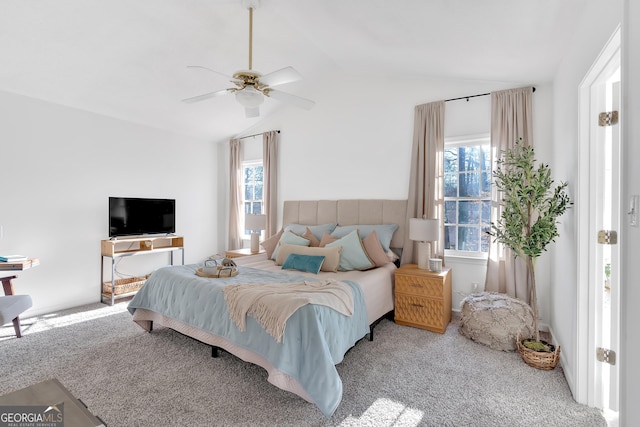 carpeted bedroom featuring vaulted ceiling and ceiling fan