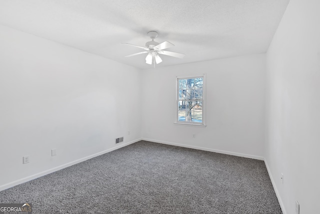 unfurnished room with ceiling fan and carpet flooring