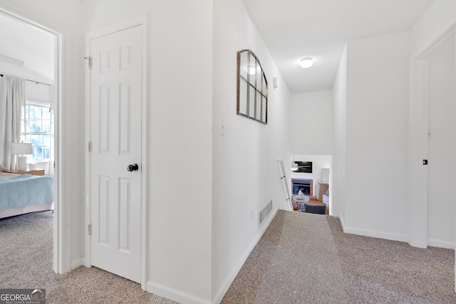 corridor featuring light carpet