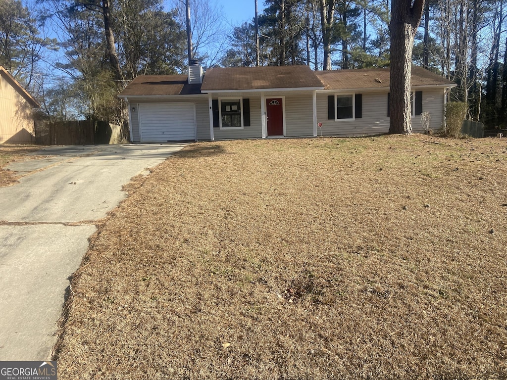 single story home with a garage and a front yard