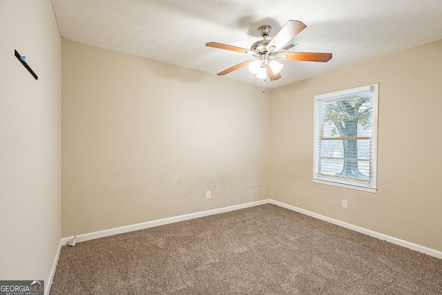 carpeted spare room with ceiling fan