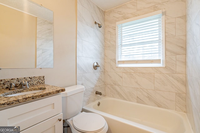 full bathroom featuring vanity, toilet, and tiled shower / bath combo