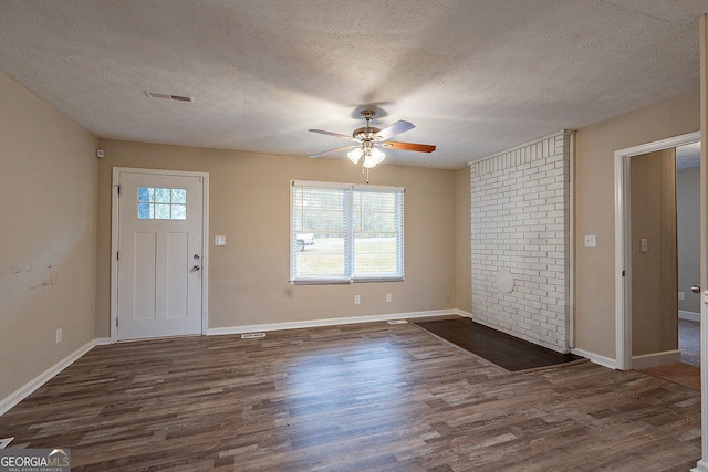 entryway featuring dark hardwood / wood-style floors, a healthy amount of sunlight, and a textured ceiling