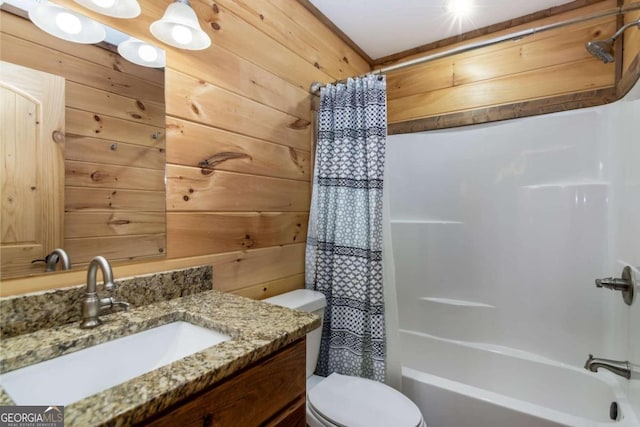 full bathroom with vanity, wood walls, toilet, and shower / bath combo with shower curtain