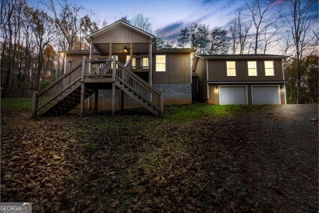 view of front of house with a garage and ceiling fan