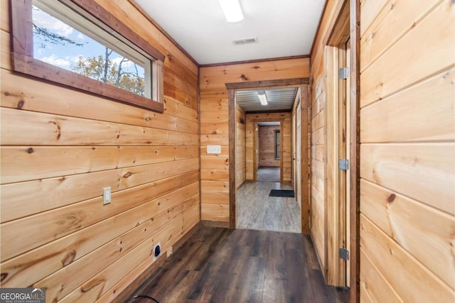 hallway featuring wood walls and dark wood-type flooring